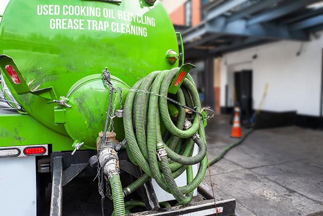 maintenance crew pumping grease trap at a fast food restaurant in Coral Springs FL